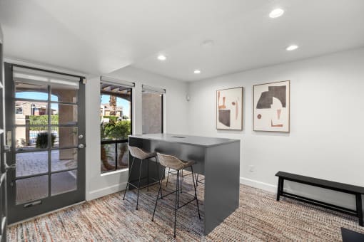 an open living room with a table and chairs in front of a patio door